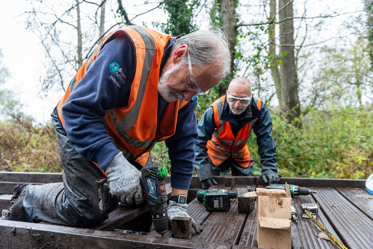 Volunteer Peter Cannell and Broads Volunteer repairing the Hoveton Boardwalk