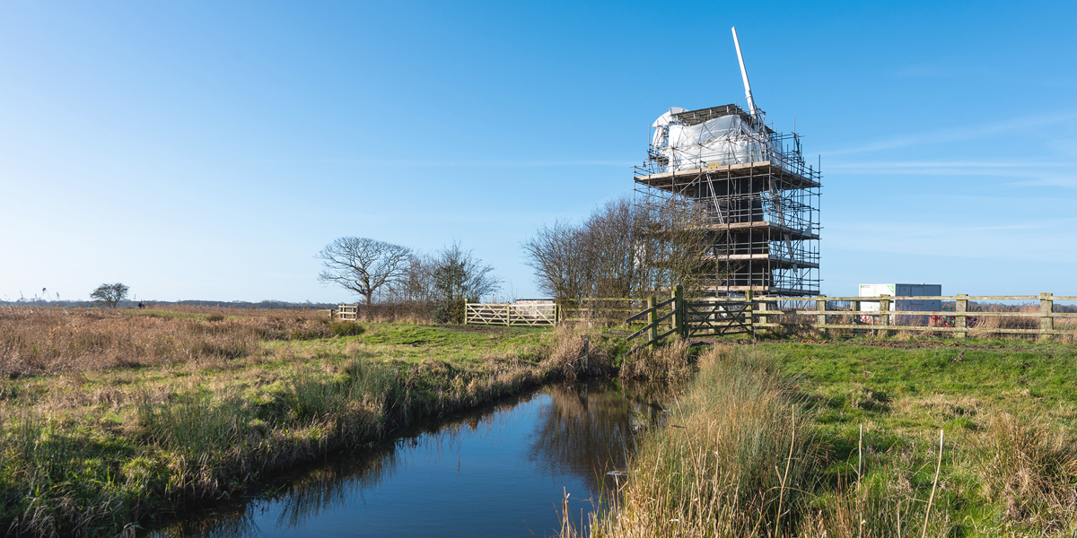 Mutton's Mill with scaffolding on a clear, sunny day