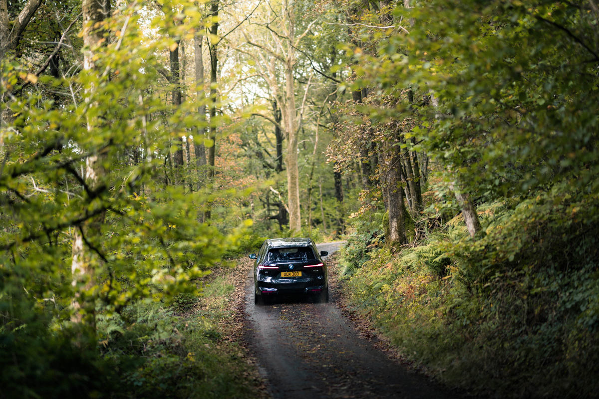 BMW EV drives down a country lane