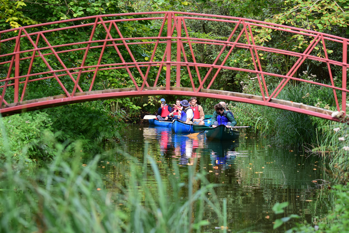 a red footbridge crossing over a dyke at fairhaven