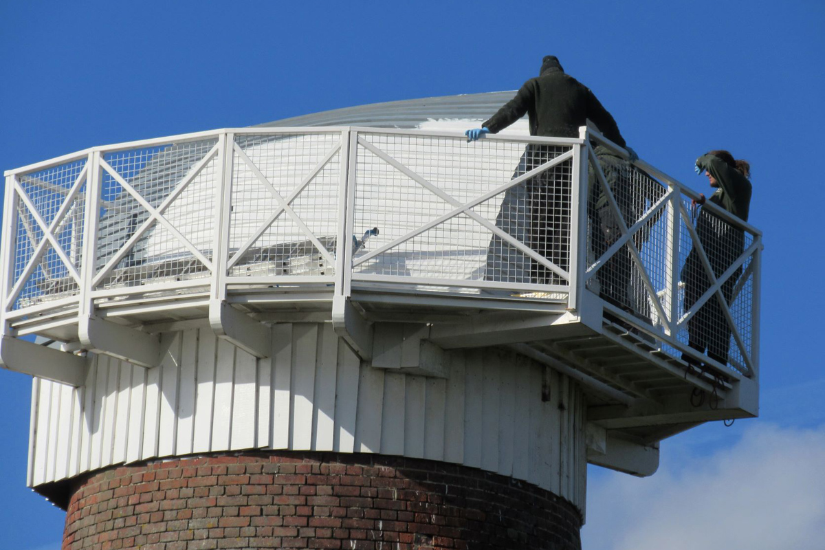 People standing on the gantry of Somerton wind pump